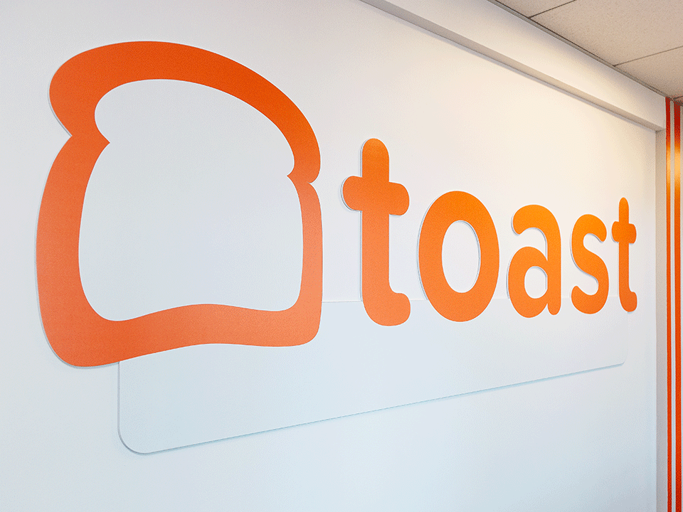 Branded wall inside of Toast's Boston office
